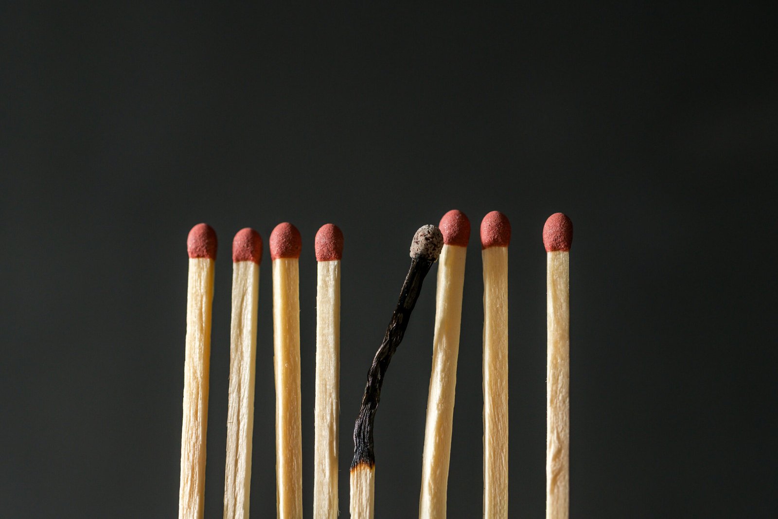 Matches and one burned match. Abstract concept of burnout, stress and depression